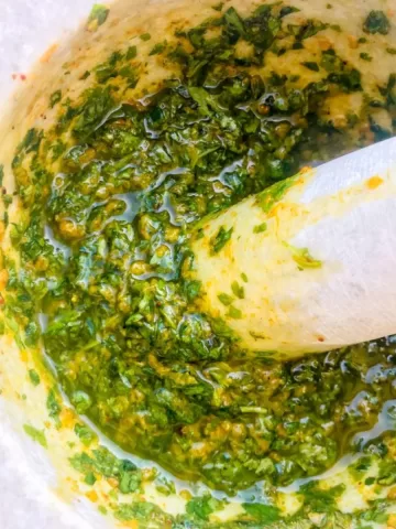 Coriander and garlic marinade - Delicious chermoula (or Charmoula) is a marinade or sauce that is most often used to accompany fish, or vegetables and poultry. In Morocco it is used in many tajine fish recipes.